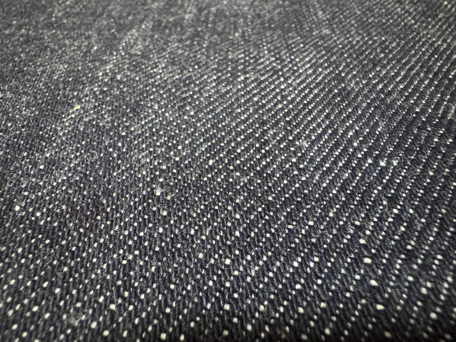 Close-up of Okayama Denim, showcasing the unique texture of 19.5 oz Japanese Heavy Ounce Indigo Selvage denim.