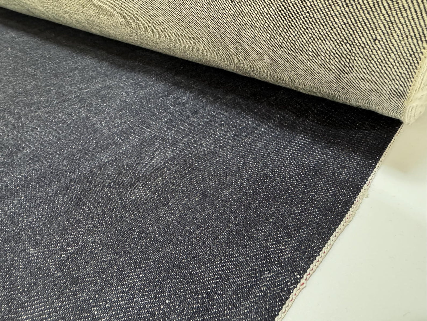 Okayama Denim 19.5 oz Japanese Heavy Ounce Indigo Selvage denim fabric roll showcasing its rich texture and character.