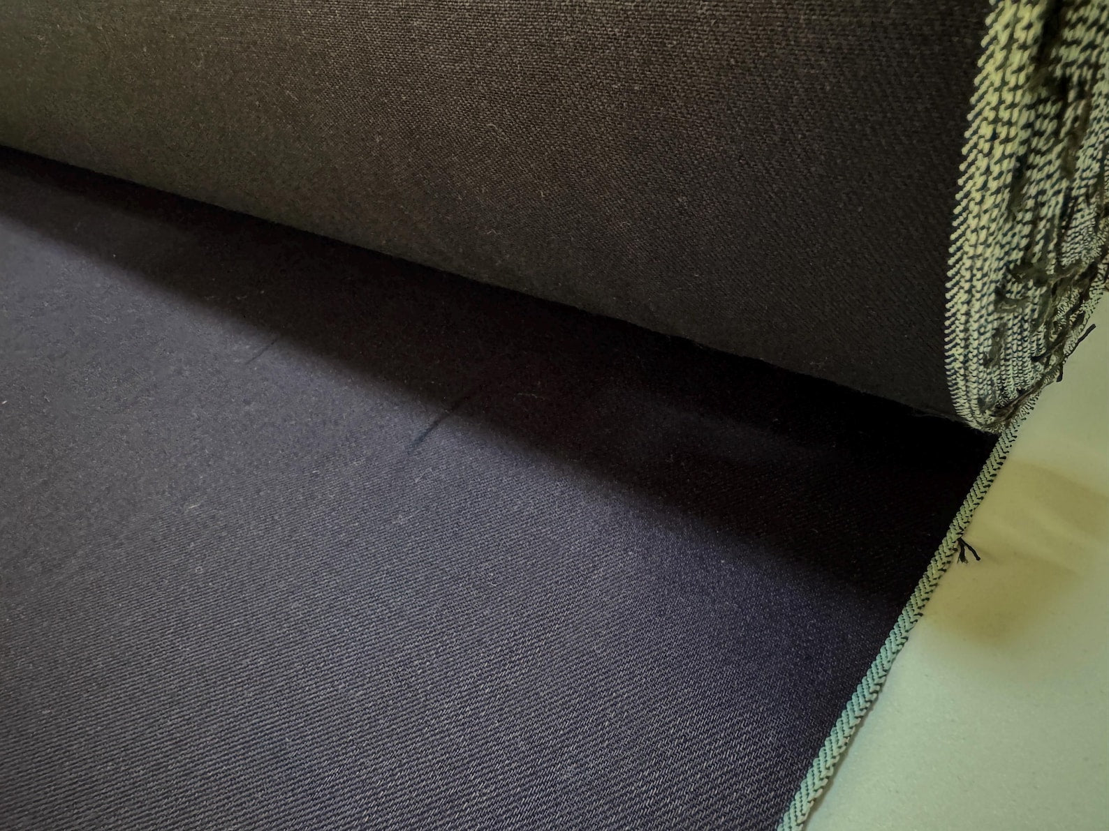 Okayama Denim 12 oz double-sided indigo selvage fabric showcasing deep navy blue color and smooth texture.