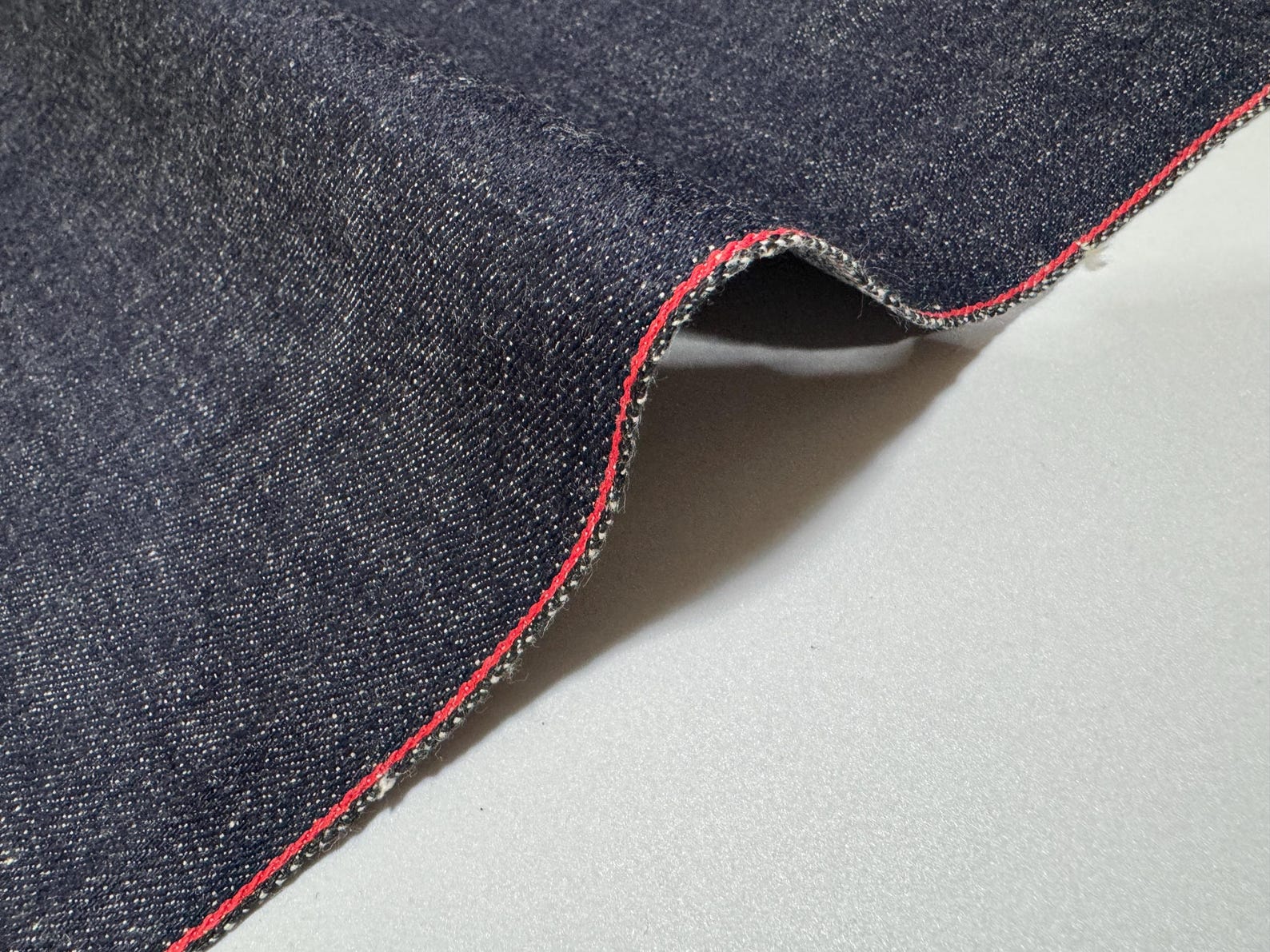 Okayama Denim | 12.5 oz Japanese Indigo Kibata Selvage Denim close-up showing the selvage edge.