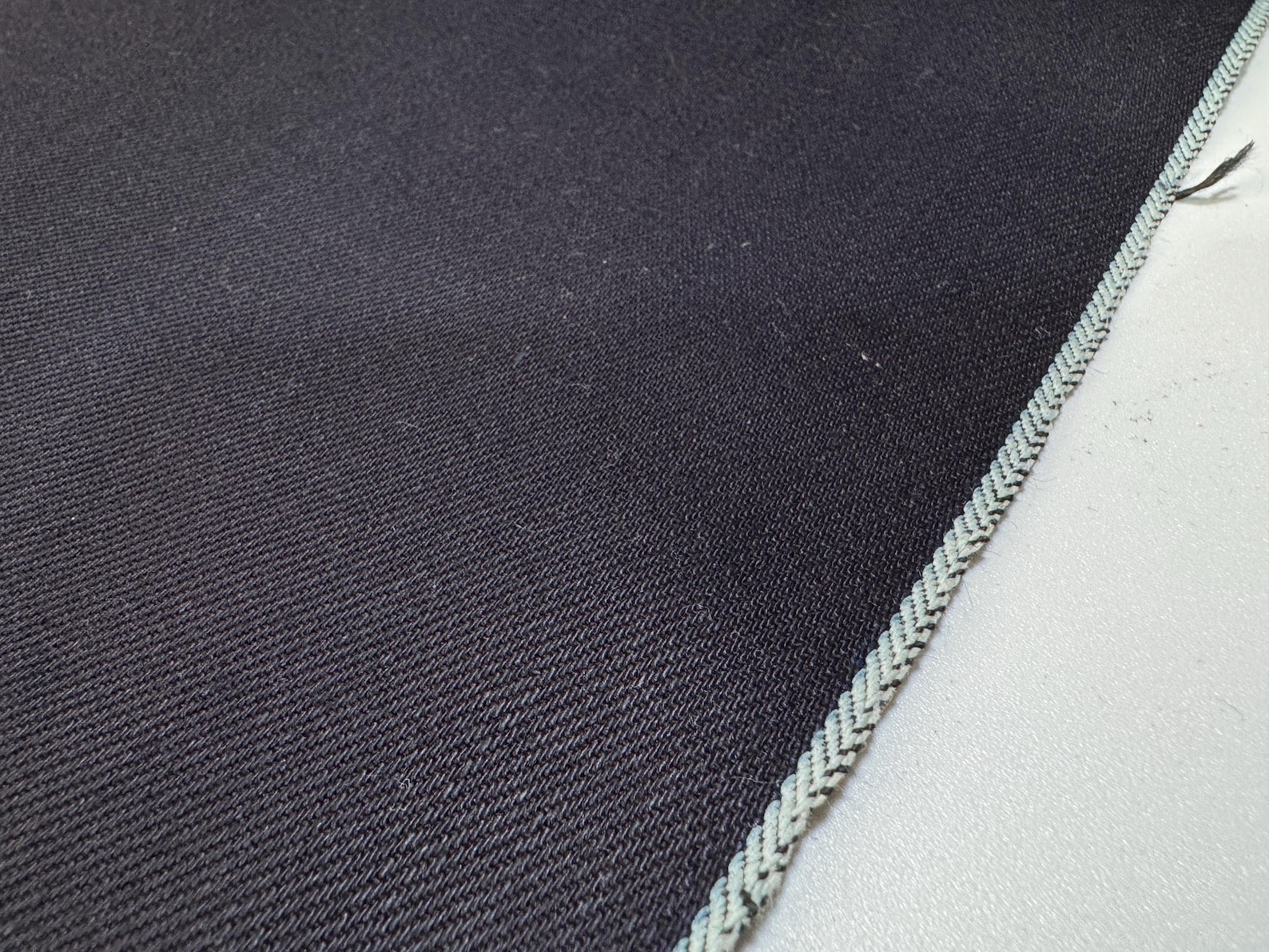 Okayama Denim 12 oz double-sided indigo selvage fabric showcasing deep navy blue color and selvedge edge.