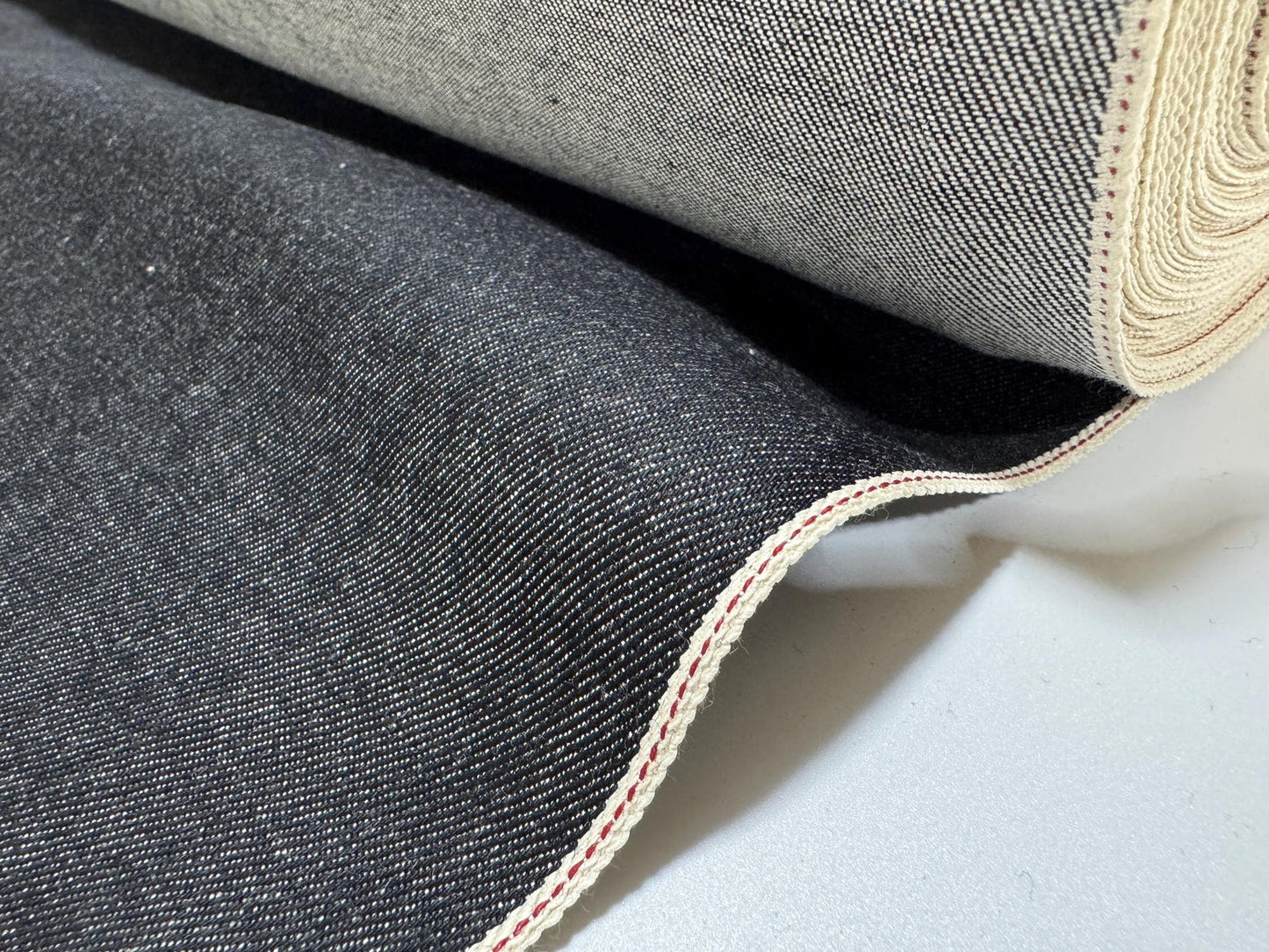 Okayama Denim 10.5 oz Japanese Cotton Black Selvage Denim fabric roll showcasing high-quality texture and durability.