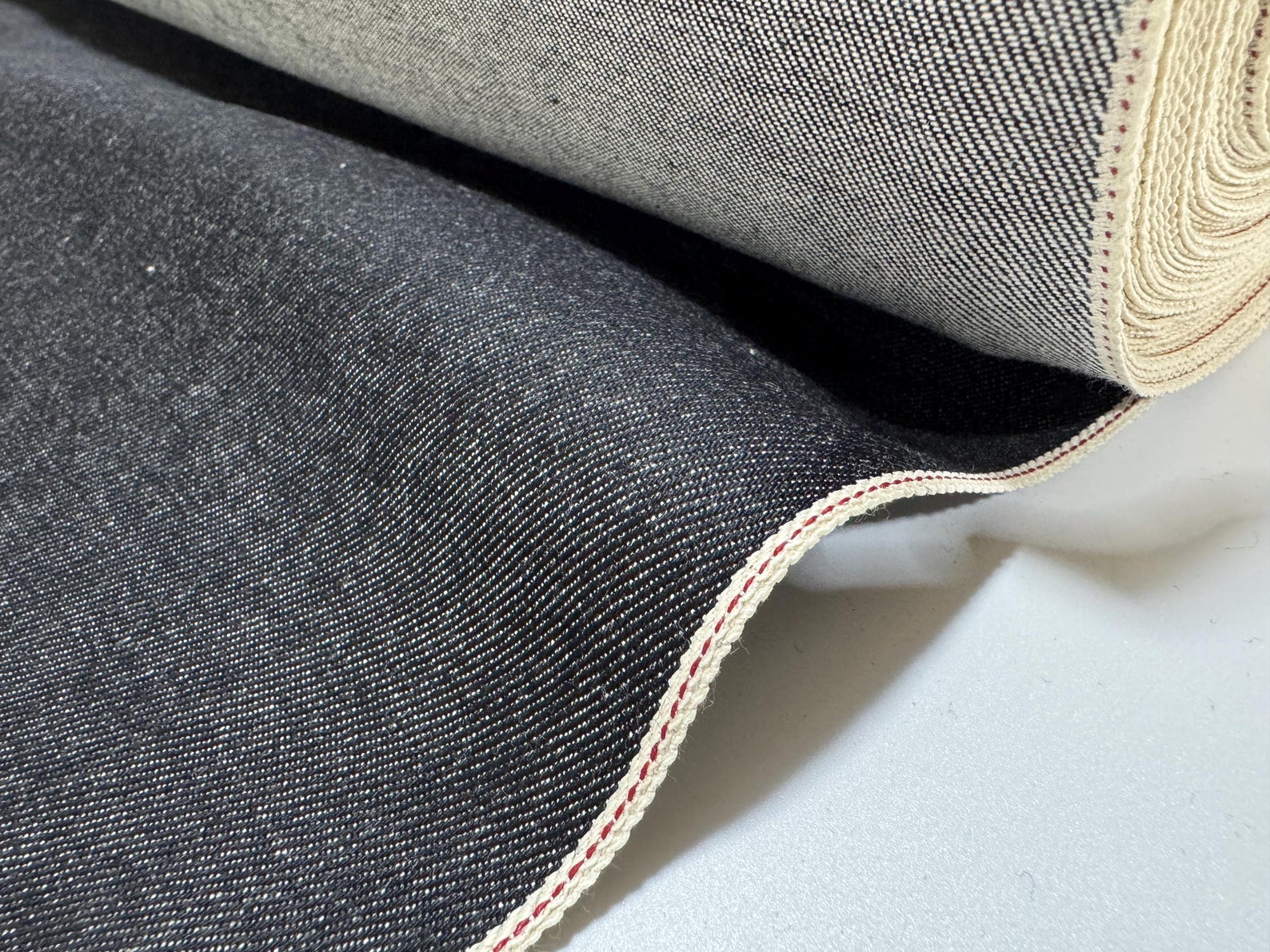 Okayama Denim 10.5 oz Japanese Cotton Black Selvage Denim fabric roll showcasing high-quality texture and durability.