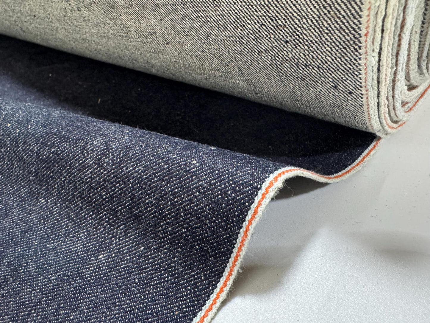 Okayama Denim 13 oz indigo kibata Japanese selvage denim fabric showing orange selvage detail.