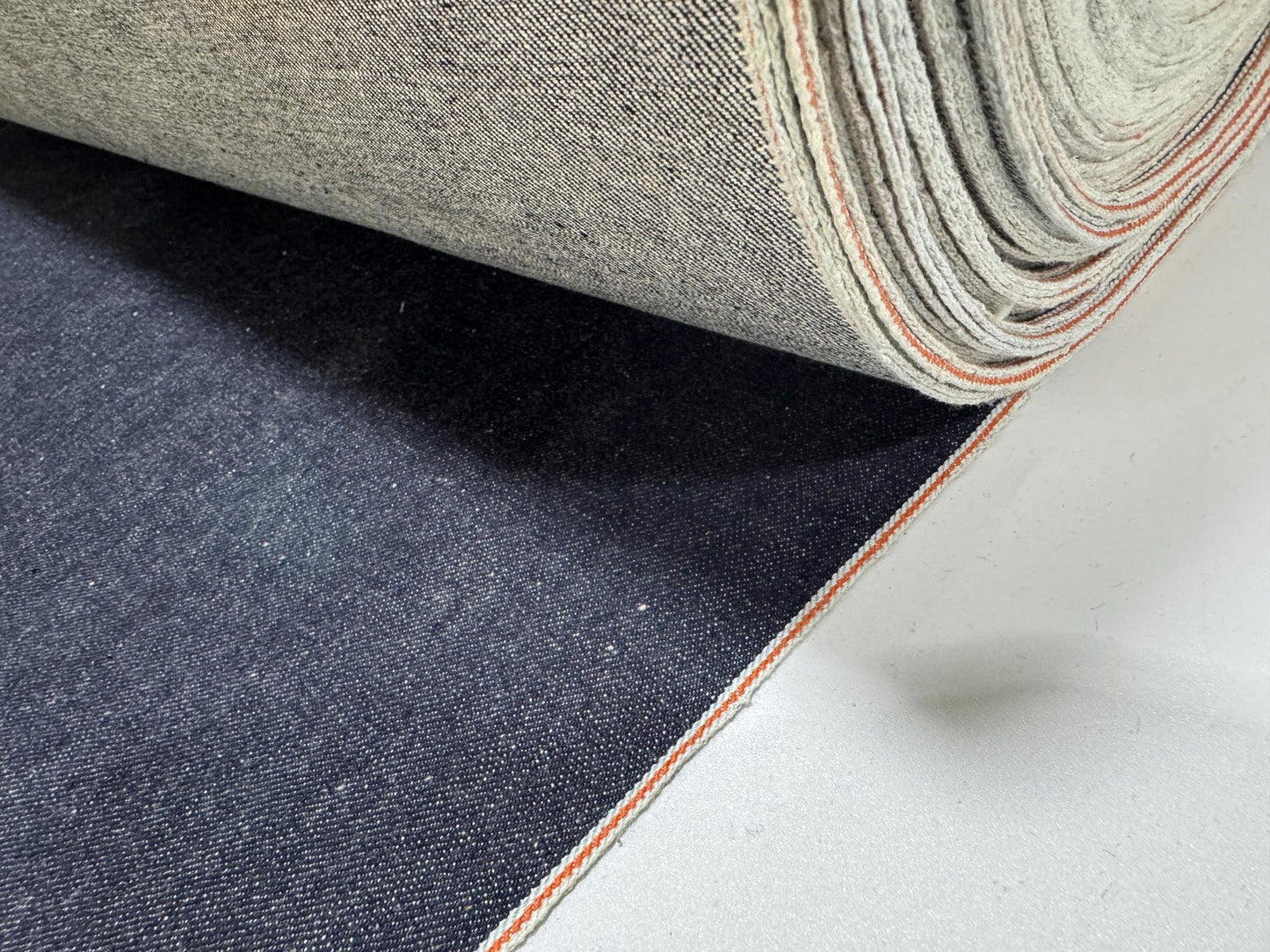 Okayama Denim 13 oz indigo kibata Japanese selvage denim fabric yard with orange selvage detail.