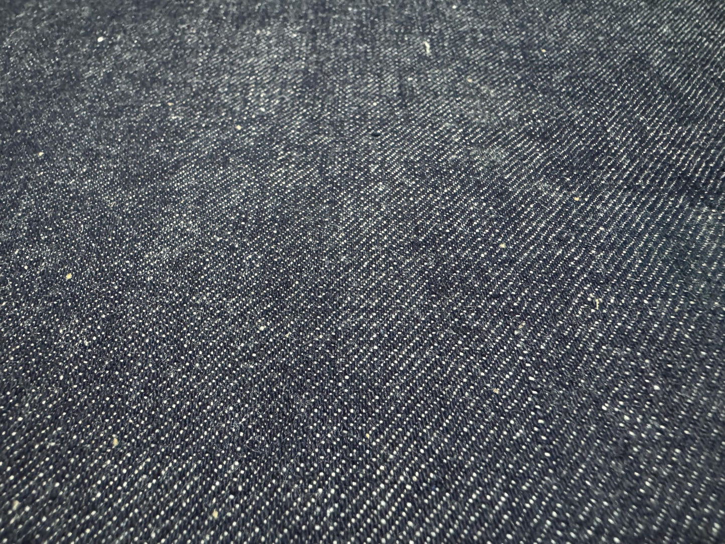 Okayama Denim 13 oz indigo kibata Japanese selvage denim fabric close-up showing texture and weave.