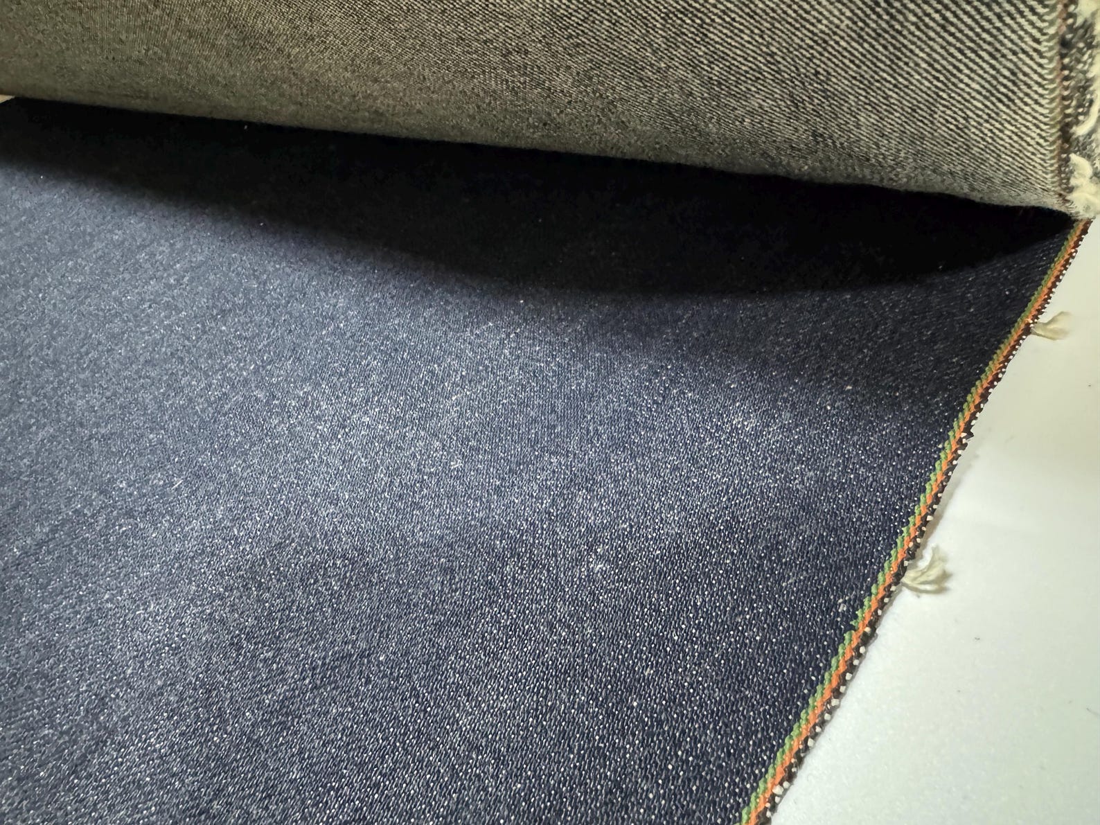 Okayama Denim 21oz Japanese heavy ounce indigo selvage fabric showcasing its rich texture and quality.