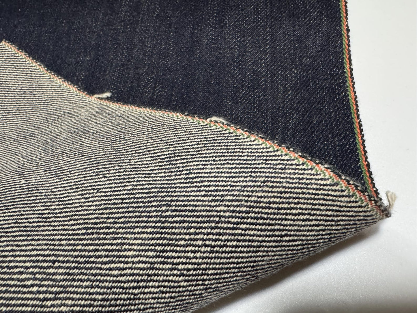 Okayama Denim 21oz Japanese heavy ounce indigo selvage showcasing intricate weave and texture details.