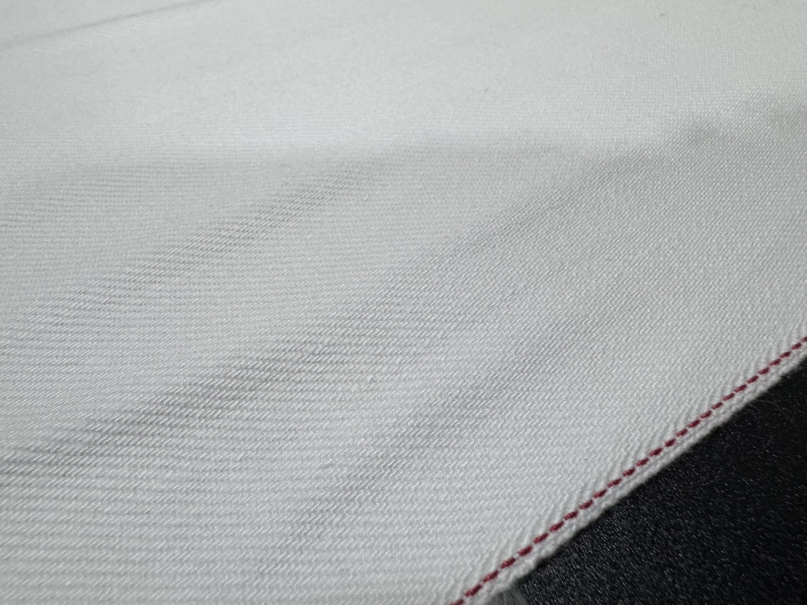 Okayama Denim fabric featuring 13 oz white selvedge with red edge, highlighting Japanese craftsmanship.