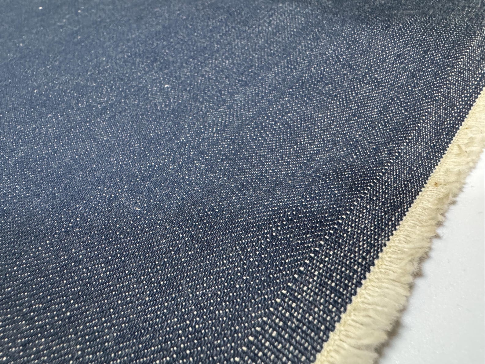 Okayama Denim | 12.5oz Double Width Indigo Japanese denim fabric close-up showing texture and color.