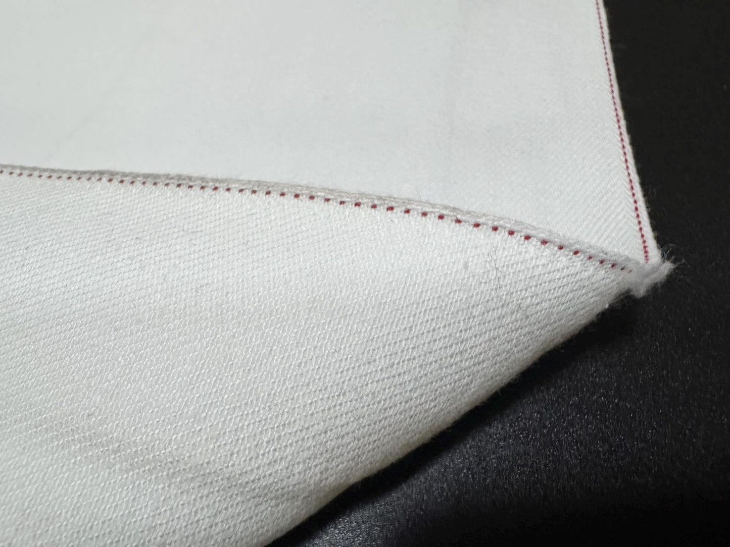 Okayama Denim 13 oz White Selvedge fabric showcasing red selvage edge detail.