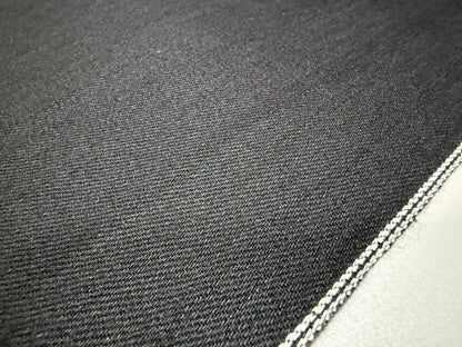 Okayama Denim | 11oz double-sided black Japanese black selvage fabric close-up showing smooth texture and selvedge