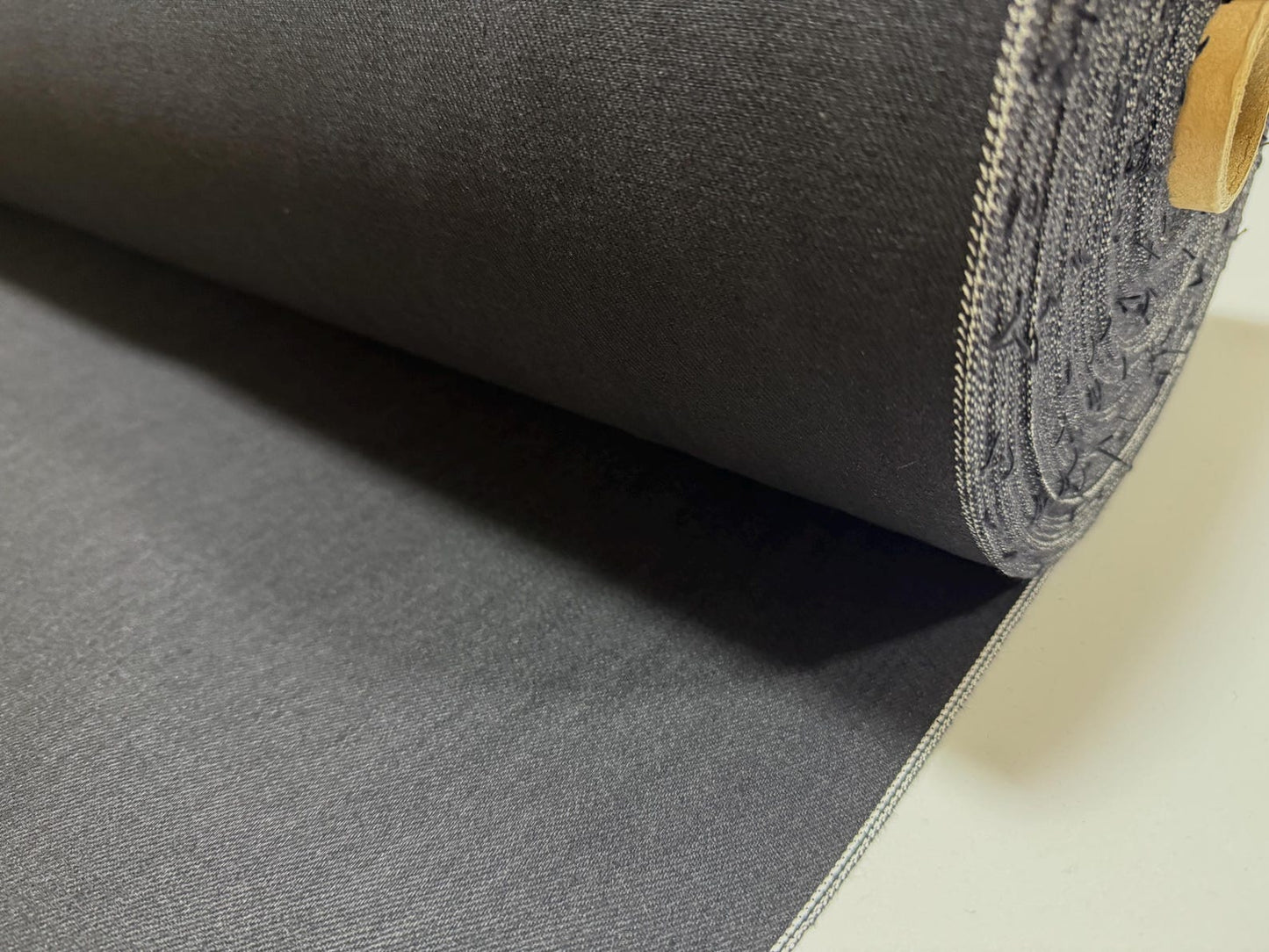 Okayama Denim | 11oz double-sided black Japanese black selvage fabric roll showcasing smooth texture.