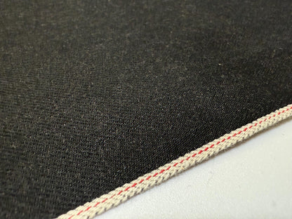 Texture of Okayama Denim | 13.5 oz black selvage Japanese denim with visible edge stitching.