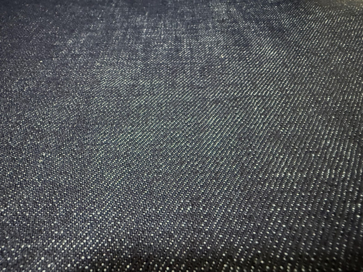 Okayama Denim 15.5oz indigo selvage Japanese blue fabric with a smooth texture and authentic weave.