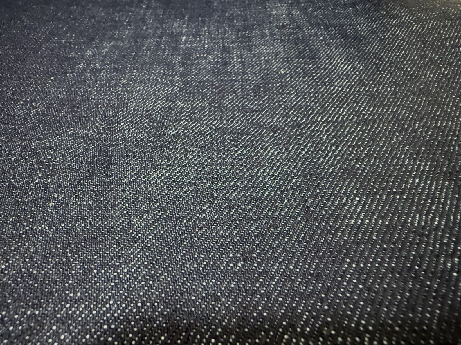 Okayama Denim 15.5oz indigo selvage Japanese blue fabric with a smooth texture and authentic weave.