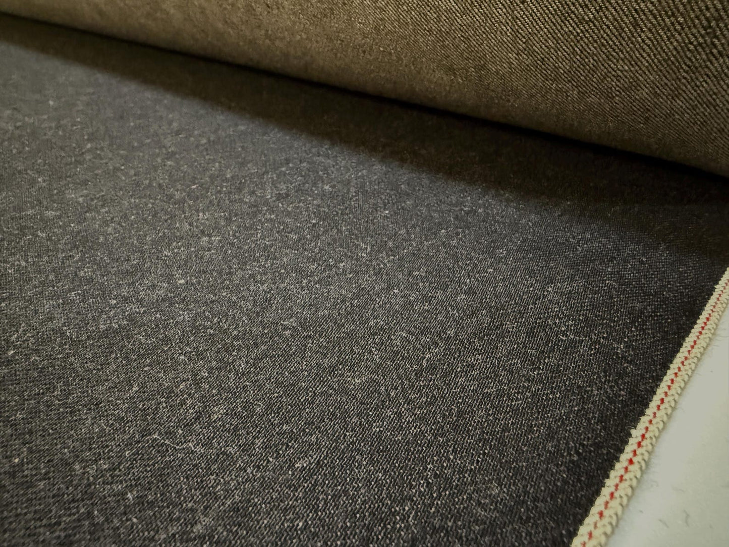 Close-up of Okayama Denim | 13.5oz black/gray Japanese Selvage Denim showcasing its texture and color.