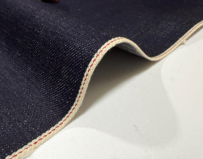 Okayama Denim 15.5oz indigo selvage blue fabric with red and white stitching, ideal for high-quality jeans.